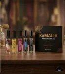 5ml glass perfume tester spray bottles displaying labels for Oud For Greatness, Stronger With You, Oud Rosewood, Oud Montaigne, and Black Opium on a wooden surface against a luxury background.